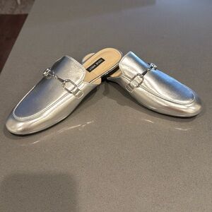 Brand new. Never worn silver Nine West loaferss